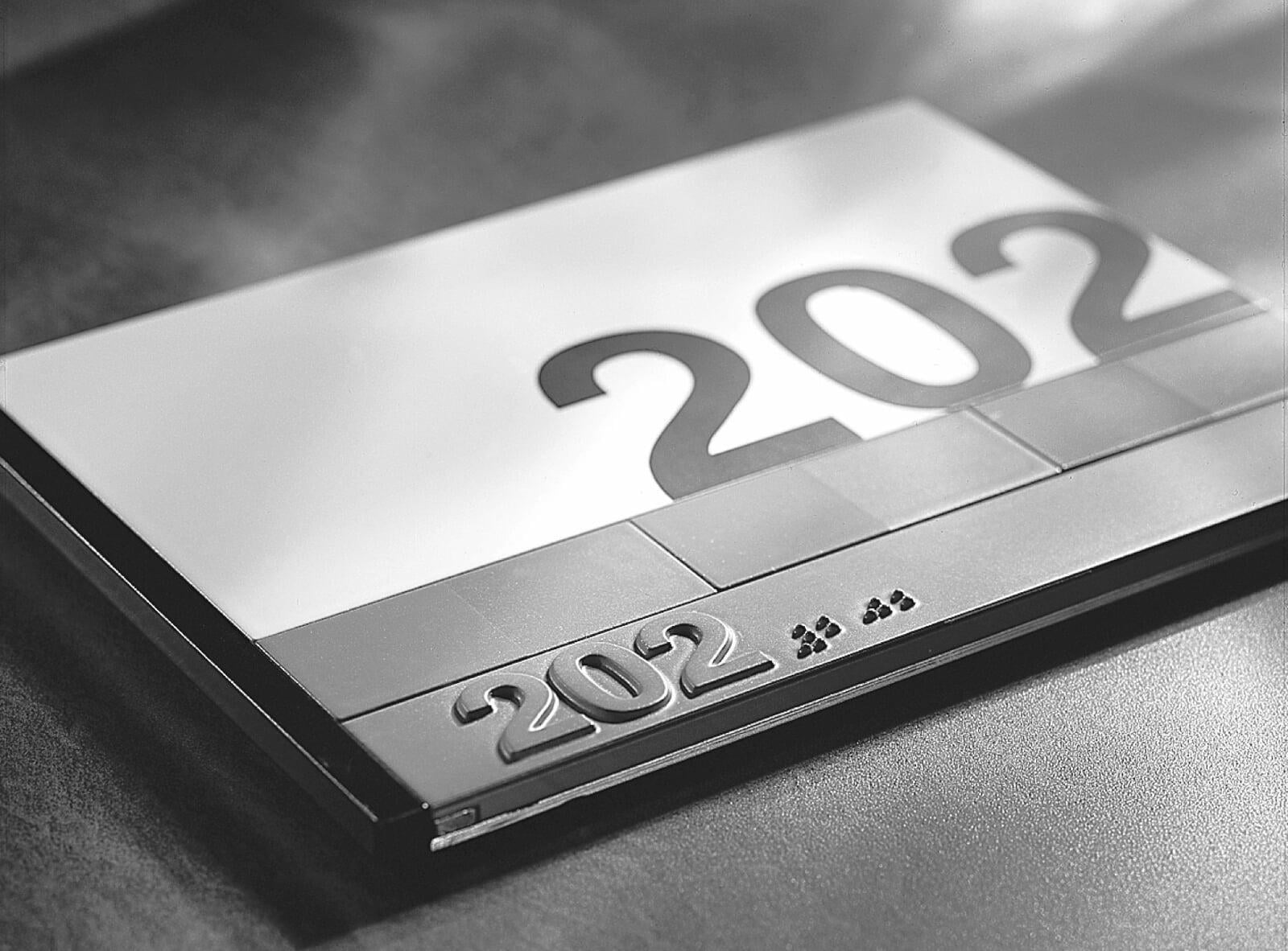 Infonorm sign frame for a hospital or office with a room number and braille.