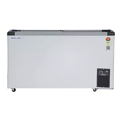 A person easily moving the Voltas GT440GA5-PL-W-G3 freezer using its durable castor wheels.