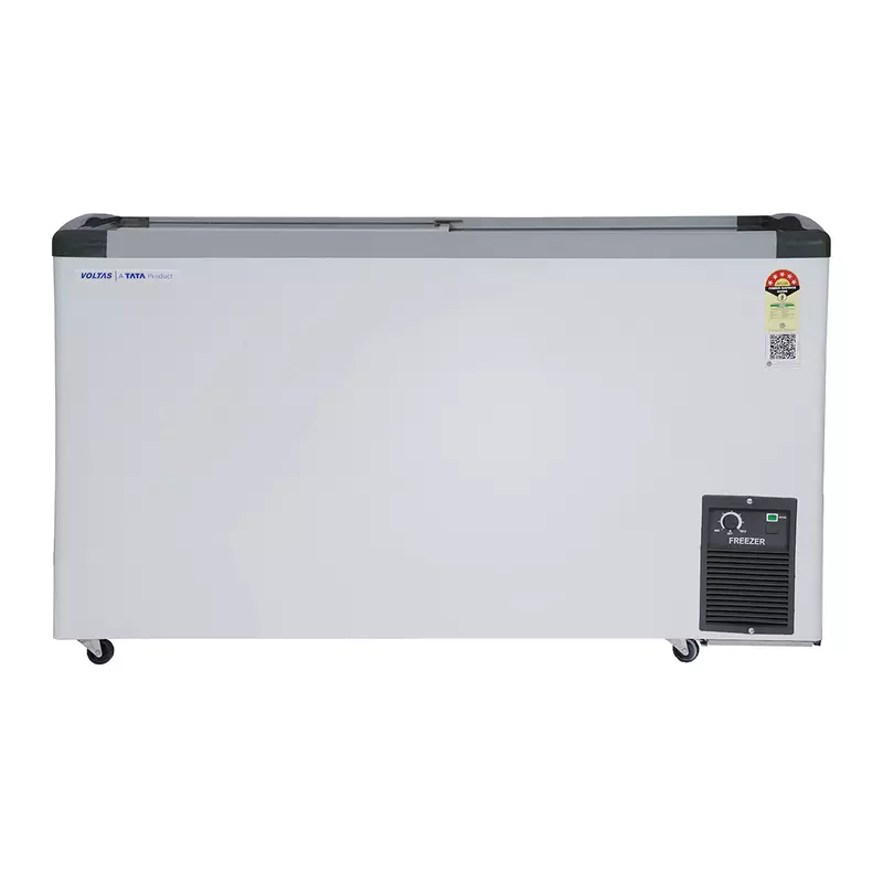 A person easily moving the Voltas GT440GA5-PL-W-G3 freezer using its durable castor wheels.