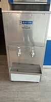 Modern office setting with the Blue Star Water Cooler SWCSDLX6080UVROE positioned in the corner.